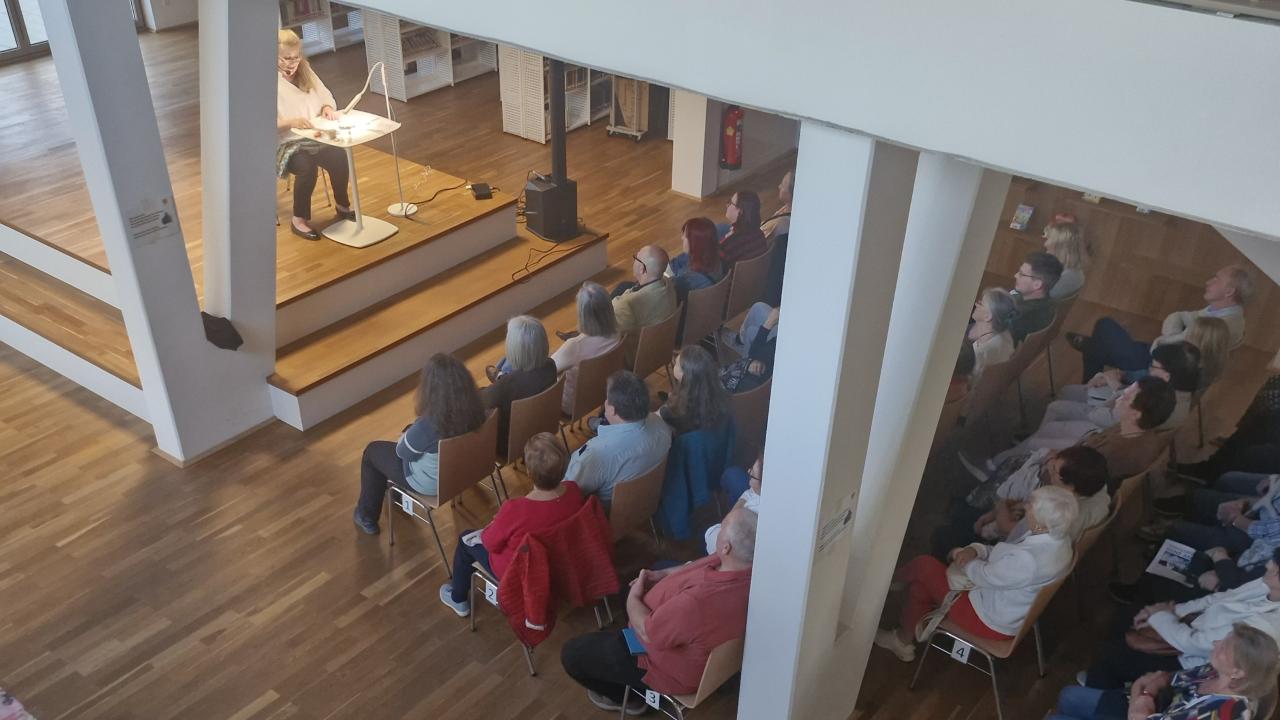 Vogelperspektive, zu sehen die Autorin auf der Bühne und das Publikum